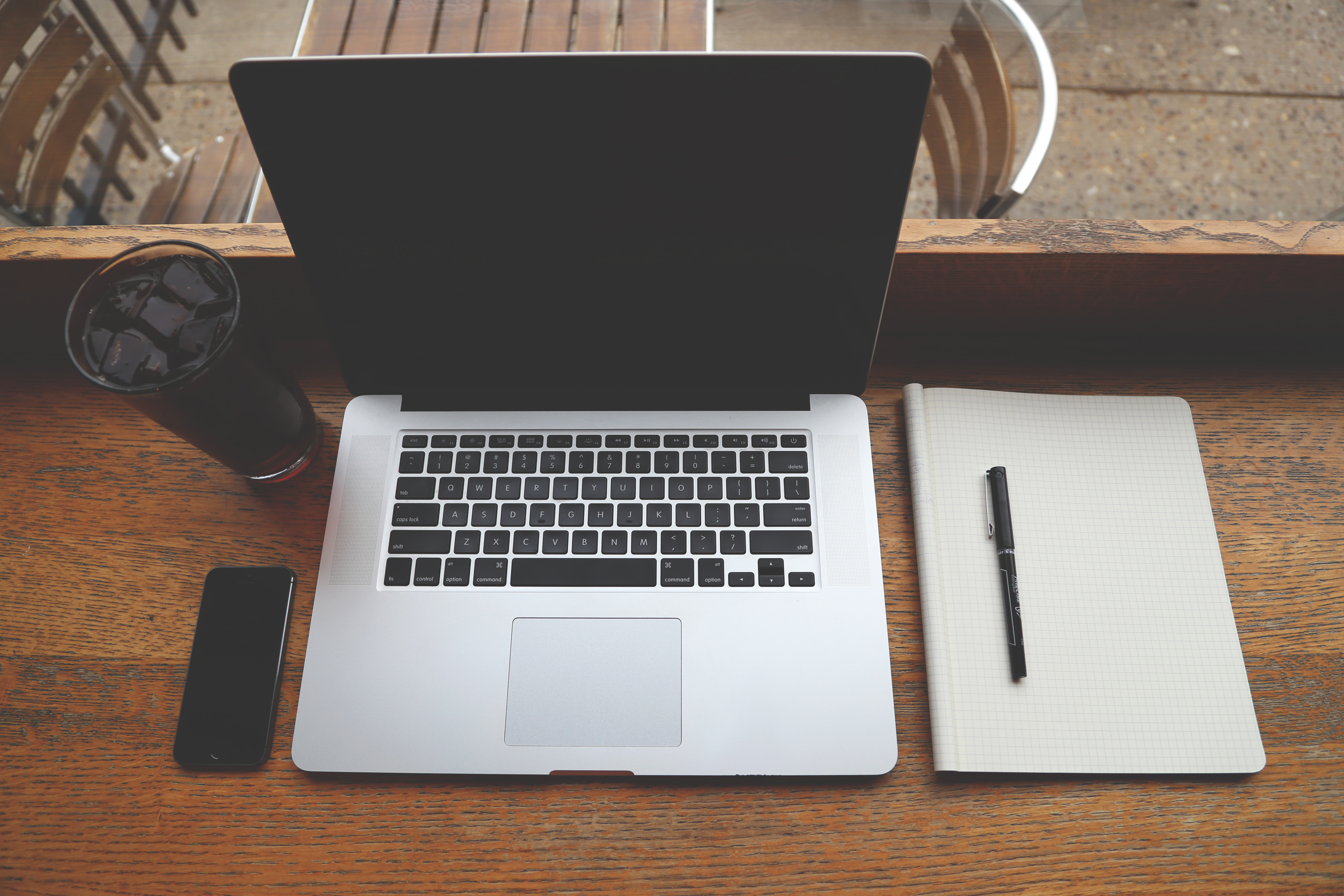 Laptop, notebook, and smartphone arranged for launch-day website checks.